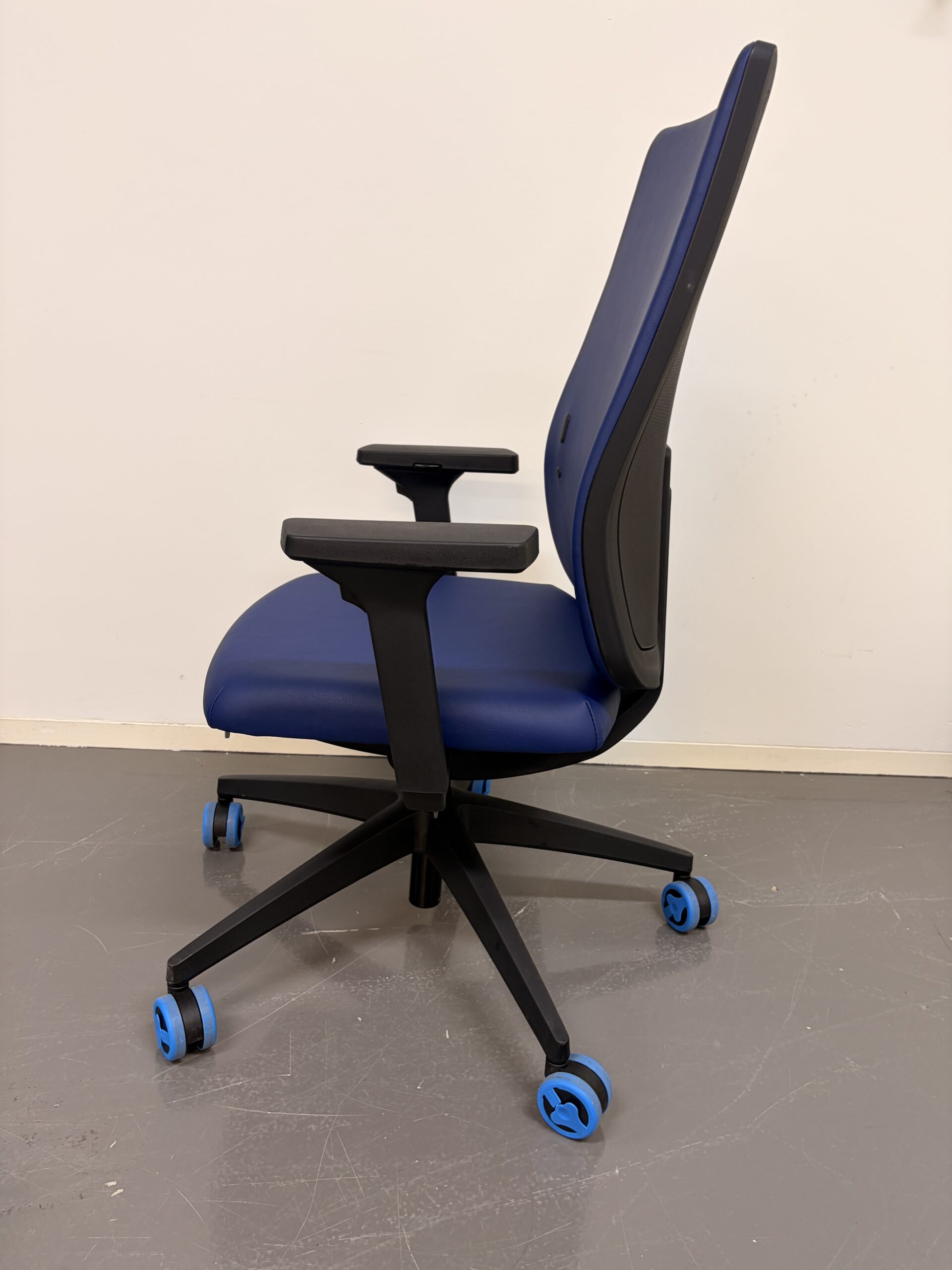 Bürostuhl mit blauer Polsterung, schwarzem Gestell und Armlehnen seite